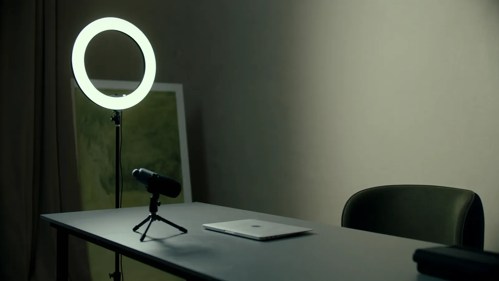 A modern personal-brand studio with a ring light, microphone and clean desk