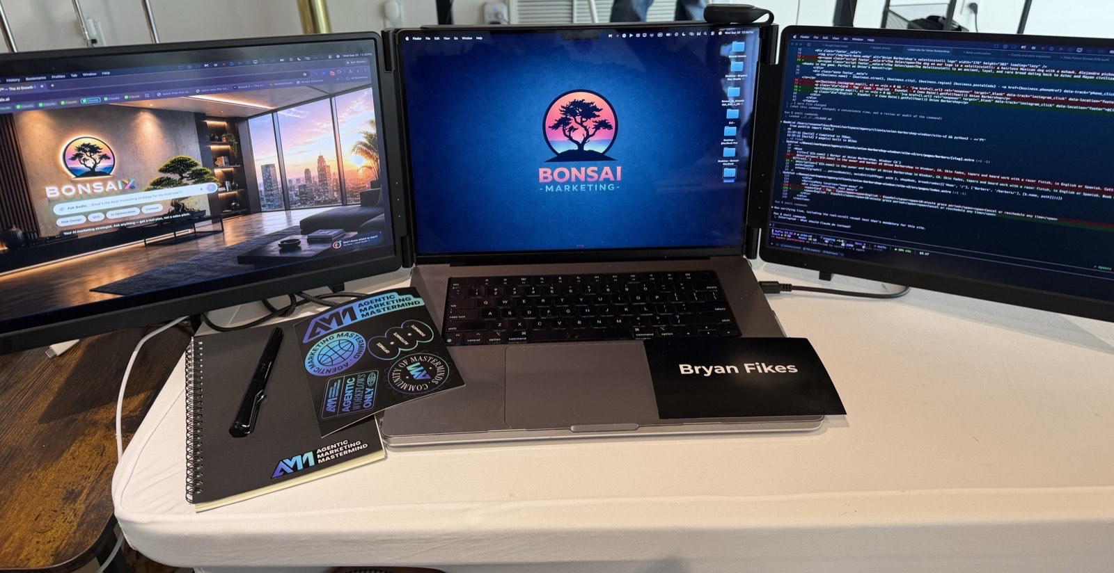 A panoramic view of the Bonsai Marketing workstation: three displays showing Bonsai branding and code, with a laptop labelled Bryan Fikes.
