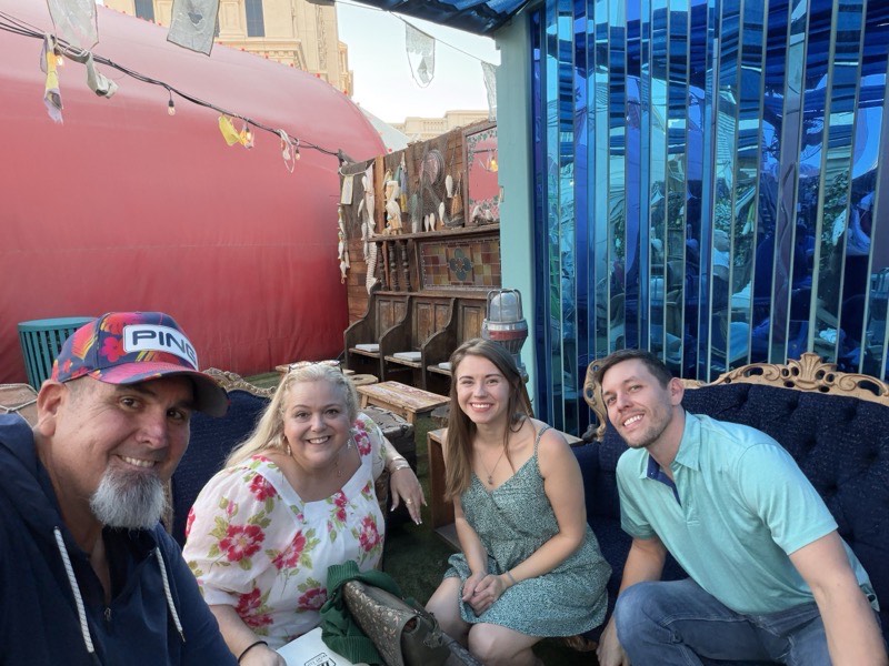 Four people seated together in a lounge.
